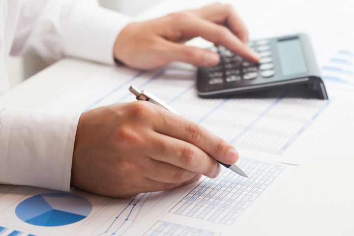 Businessman checking numbers on a document